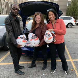 All Access CDC's Randy Glover and Joellen Green (far right) received frozen turkeys from the NNJCF's Mary Call Blanusa (center).