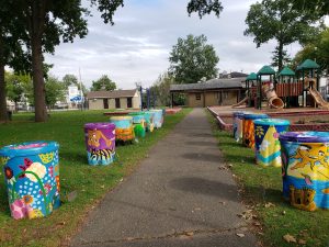The Environmental Justice Alliance identifies solutions to flooding such as painted rain barrels to lessen the impact of flooding.