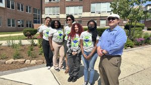 Leonardo Vazquez, Executive Director of the Northern New Jersey Community Foundation, led the PSEG ISS Green Team from Montclair State University on a tour of the Community Rain Garden at Hackensck High School.